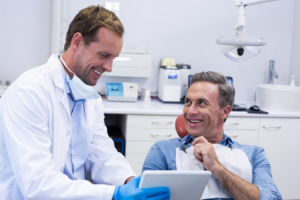 Dentist and patient talking during cosmetic dental consultation 