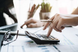 Close up of someone calculating their Invisalign schedule with a calculator