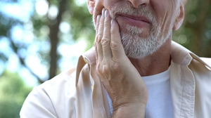 Close up of bearded man with jaw pain